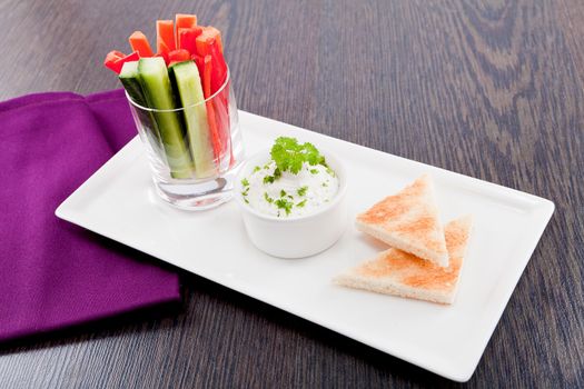 fresh vegetables snack and cream cheese dip with bread on plate