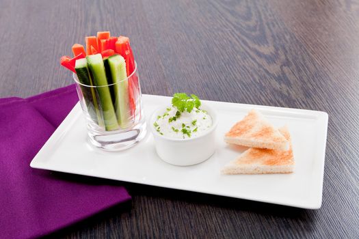 fresh vegetables snack and cream cheese dip with bread on plate