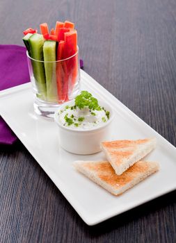 fresh vegetables snack and cream cheese dip with bread on plate