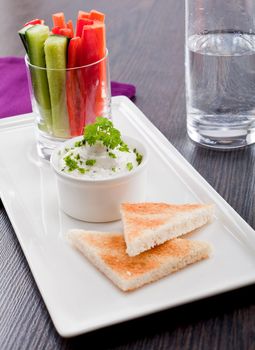 fresh vegetables snack and cream cheese dip with bread on plate