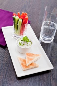 fresh vegetables snack and cream cheese dip with bread on plate