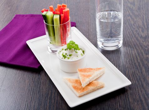 fresh vegetables snack and cream cheese dip with bread on plate