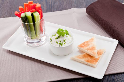 fresh vegetables snack and cream cheese dip with bread on plate