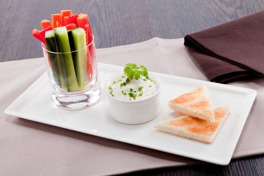 fresh vegetables snack and cream cheese dip with bread on plate