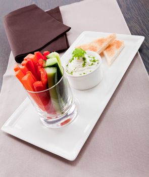 fresh vegetables snack and cream cheese dip with bread on plate