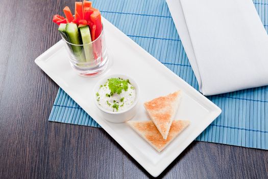 fresh vegetables snack and cream cheese dip with bread on plate