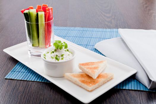 fresh vegetables snack and cream cheese dip with bread on plate