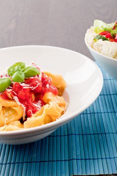 tasty fresh homemade ravioli with tomato sauce basil and parmesan