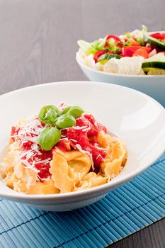 tasty fresh homemade ravioli with tomato sauce basil and parmesan