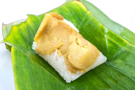 Thai dessert, Sticky rice with steamed custard, wrapped in banana leaves.