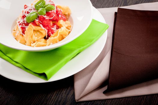 tasty fresh homemade ravioli with tomato sauce basil and parmesan