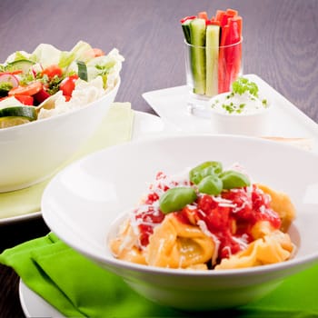 collection of different plates with healthy food pasta salad vegetables on wooden table