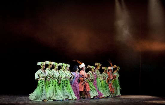 CHENGDU - MAY 6: Chinese Qiang ethnic dancers perform folk dance onstage at JiaoZi theater on May 6, 2009 in Chengdu, China.