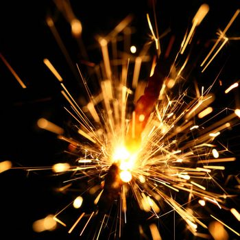 yellow sparkler holiday background on black