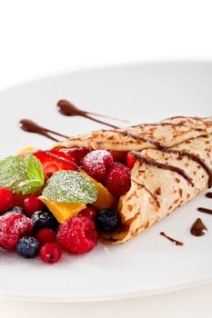 fresh tasty homemade crepe pancake with chocolate sauce fruits and berries