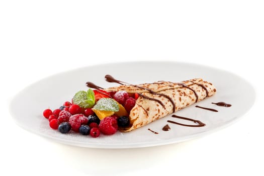 fresh tasty homemade crepe pancake with chocolate sauce fruits and berries
