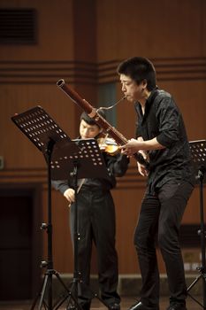 CHENGDU - JUN 20: bassoonist perform on wind music chamber music concert at odeum of Sichuan Conservatory of Music on Jun 20,2012 in Chengdu,China.