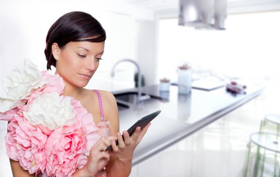 fashion woman and tablet ebook reading on kitchen with spring pink flowers dress