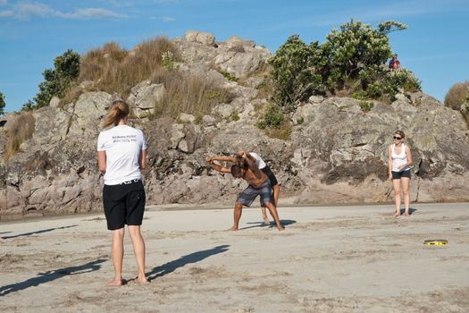 TAURANGA, NEW ZEALAND - JANUARY 23: Group of youths practice the art of capoeira on the Mount Maunganui beach, Tauranga New Zealand on January 23 2012. The sport, founded in Brazil is growing globaly.