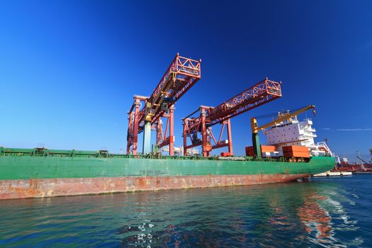 cranes and container ship in Genoa harbor, Italy