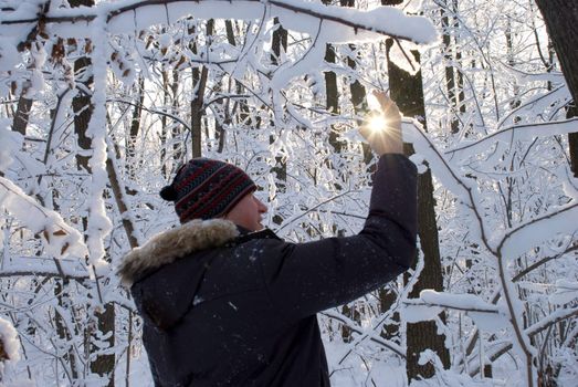 man holding a sun in his hands against the sky