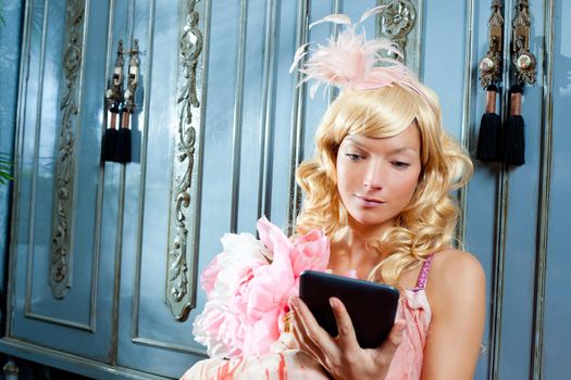 blond fashion princess woman reading ebook tablet with retro spring pink dress