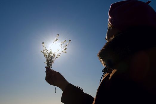 woman with a flower in the sun