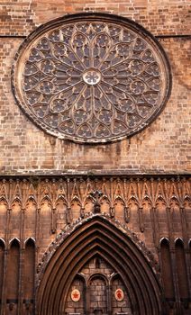 Rose Stained Glass Window, Old Stone Basilica, St Maria del Pi, Saint Mary of Pine Tree, in Barcelona, Catalonia, Spain. Saint Maria del Pi was founded in 987AD or earlier. This is one of the largest rose windows in the World and was created in 1380.