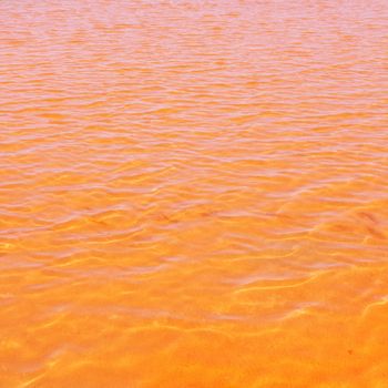 Formentera Ses Salines saltworks red orange water lakes with ripple waves