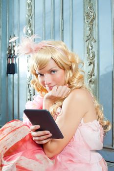 blond fashion princess woman reading ebook tablet with retro spring pink dress