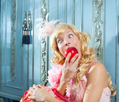 blond fashion princess eating apple with funny eyes expression