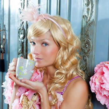 blond fashion princess woman drinking tea or coffee at home with vintage pink dress