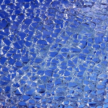 broken glass cracked over blue background pattern