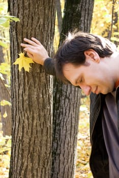 man standing near the tree in autumn forest