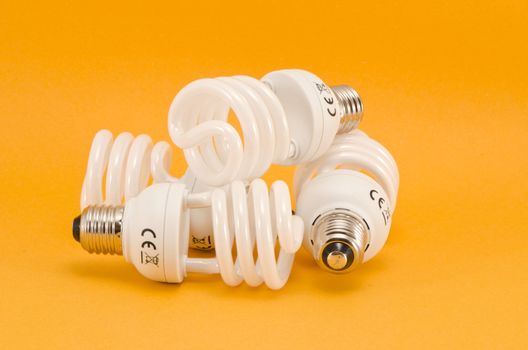 three new modern electric bulbs group on yellow background