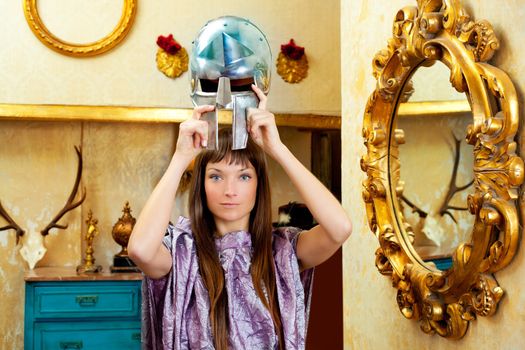 Futuristic fashion woman in retro grunge home with steel helmet