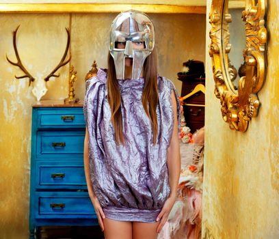 Futuristic fashion woman in retro grunge home with steel helmet