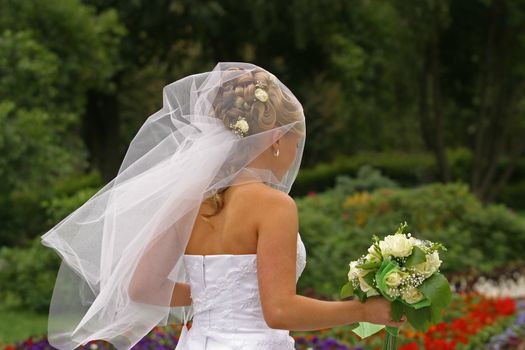 The bride walks in park