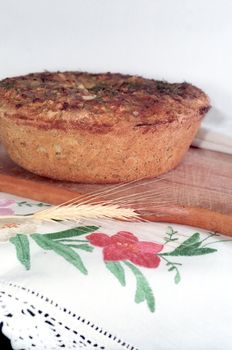 Feta cheese bread on the wooden breadboard with a spike