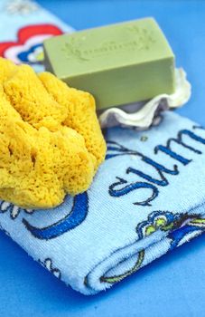 Beach towel, natural olive soap on clamshell valve and sea sponge