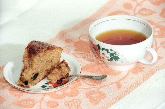 Chocolate cake and cup of tea on the table