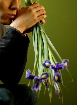Young the man with a bouquet of irises in hands