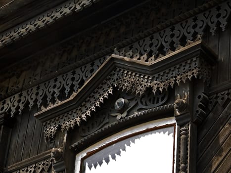 Platband windows, decorated with wooden carvings