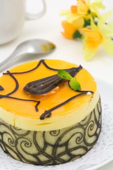 Mango chocolate cake decorated with mint leaves and swirls