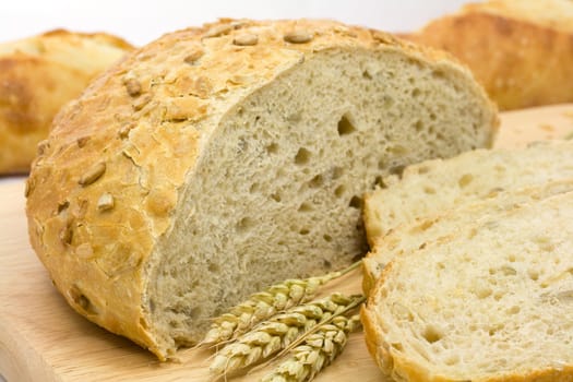 Fresh bread loaf and baguette with wheat ears