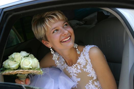The laughing bride in the car
