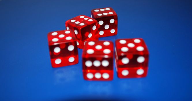 five red dice on a blue background