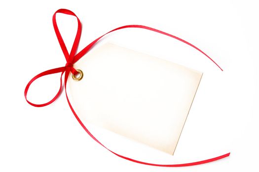 blank gift tag tied with a red bow and shot on a white background.