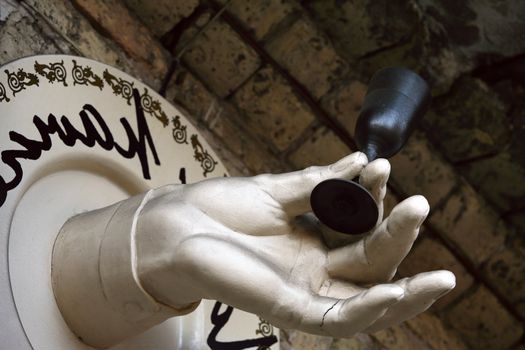 The image of an artificial hand with a glass