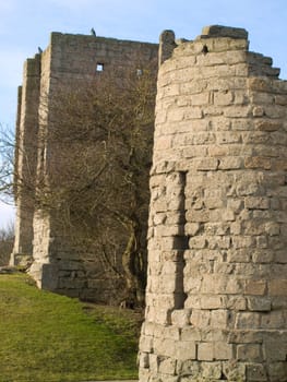 An old castle window in the shape of a cross